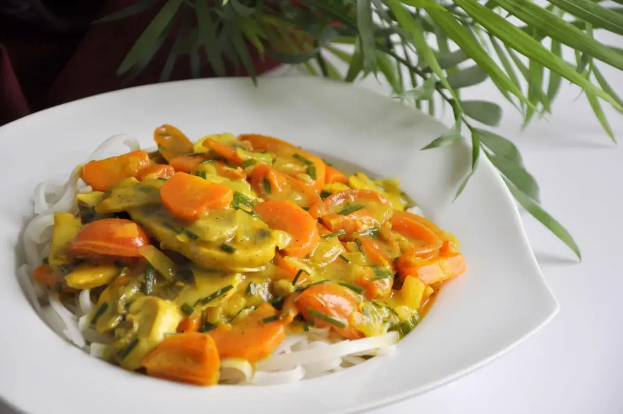 Pyszne danie z makaronem ryżowym, marchewką i innymi warzywami w kremowym sosie curry. Idealne, by coś zjeść!